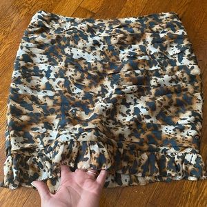 Animal print skirt with mini pleated hem.